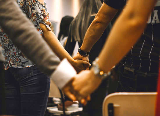 Hands clasped together in support